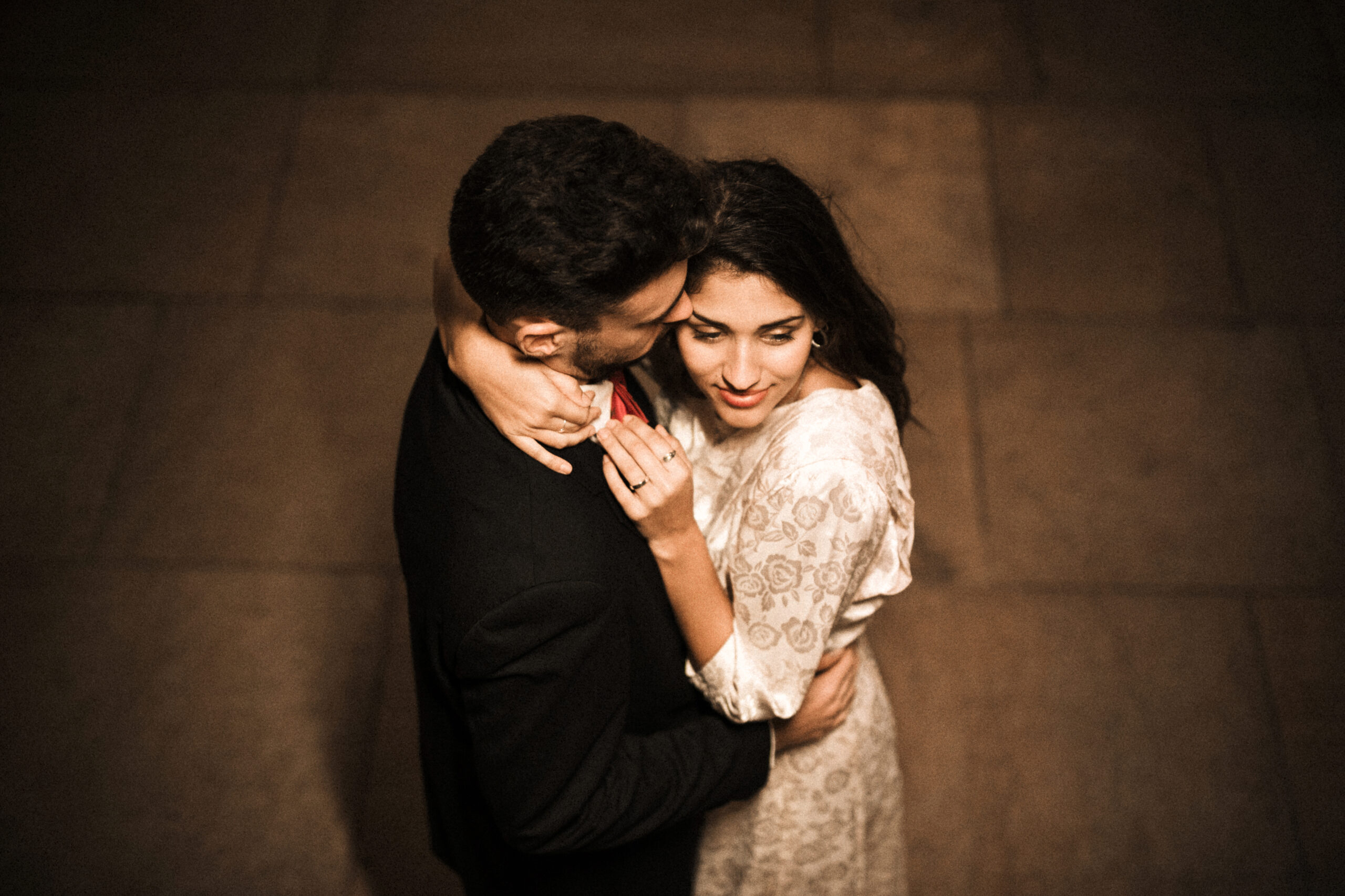 young man embracing charming woman